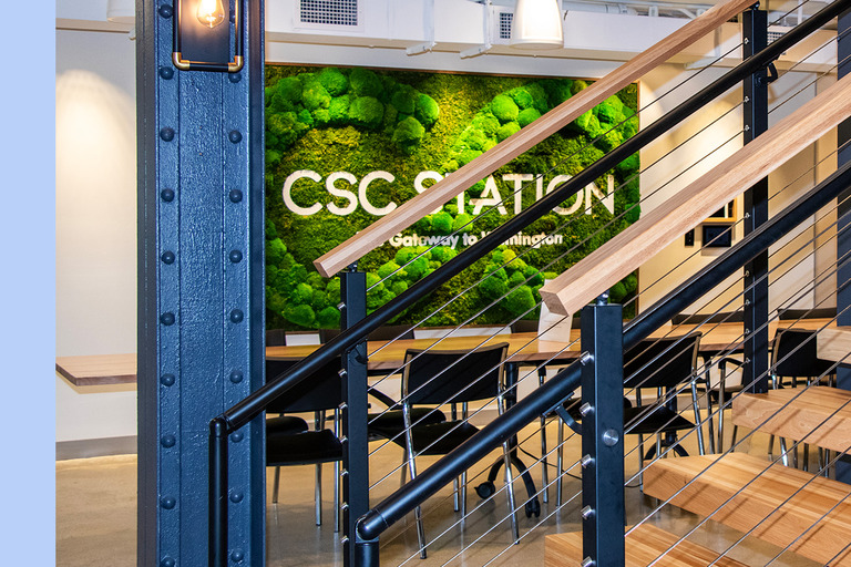 The CSC Station moss wall beside the staircase